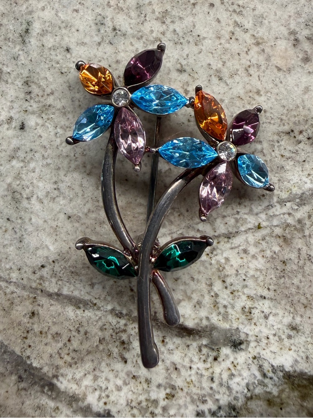 Vintage Monet silver tone/rhinestone pinwheel flower brooch .